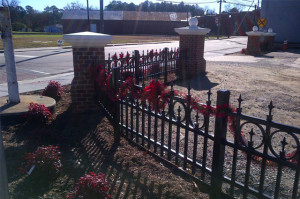 Decorative brick columns with ornamental fence.