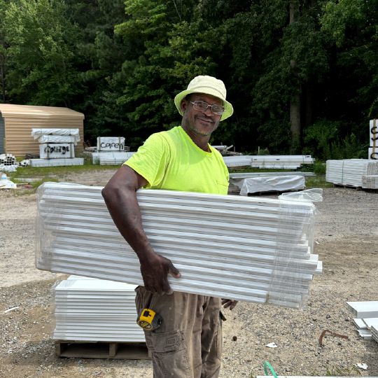 Employee holding vinyl fencing
