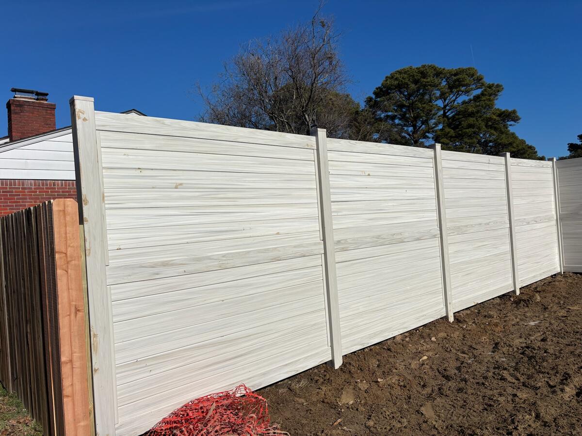 Custom vinyl fence installation by Chesapeake Fence